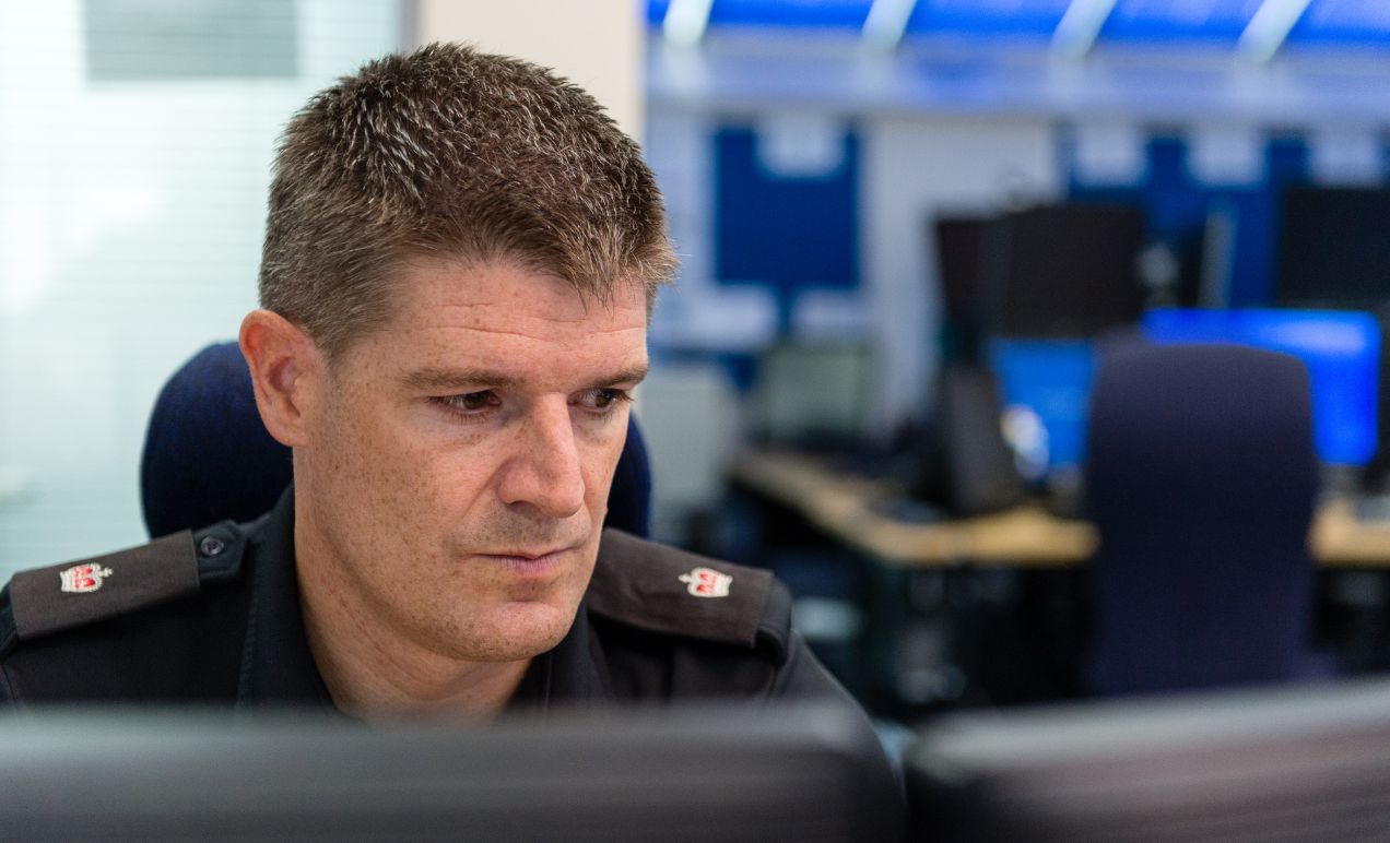 A Police officer reviews digital evidence in the cloud